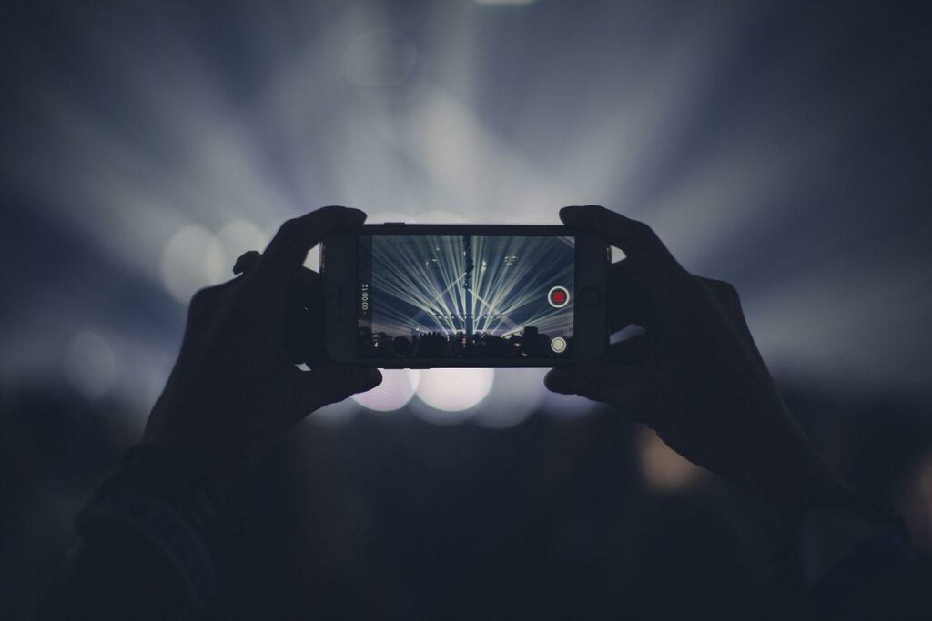 Free phone camera recording image - a person taking a photo of a concert